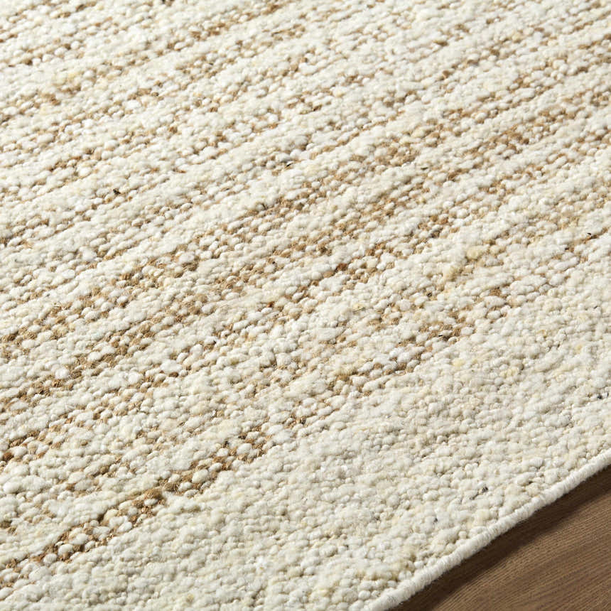Close-up of the Yaron Area Rug showing the pearl and tan jute and wool texture and hand woven construction. Texture