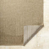 Close-up of the Yuley Brown Area Rug showing its woven texture, prairie dust and tan colors, and folded corner. Fold