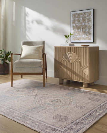 Living room scene with a beige Yamka Area Rug, gray chair, and modern wood cabinet. Roomscene-Rectangle
