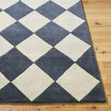 Close up of the Aradia Charcoal Area Rug. Hand-tufted wool rug with a contemporary diamond pattern in charcoal and cream. Front