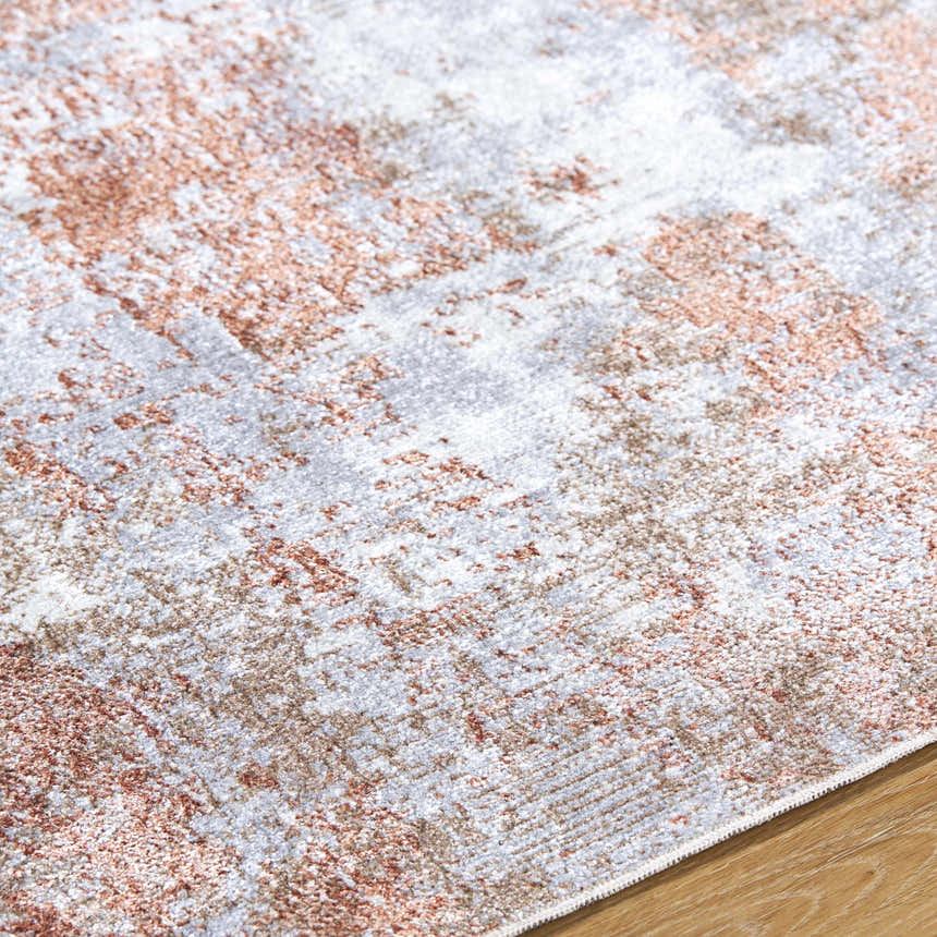 Close-up of the Anitra Brown Washable Area Rug. Abstract design in brown, light gray, and white on soft polyester. Texture