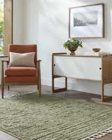 Living room scene with olive Annily Area Rug, orange chair, and modern white cabinet. Roomscene-Rectangle