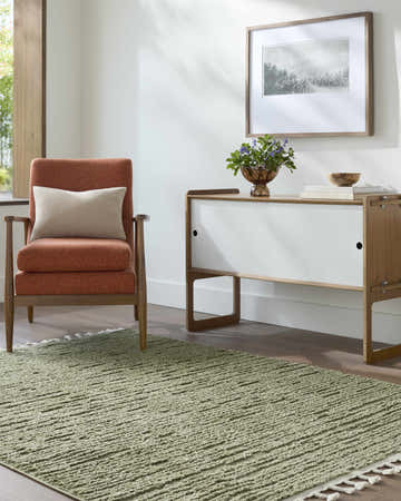 Living room scene with olive Annily Area Rug, orange chair, and modern white cabinet. Roomscene-Rectangle