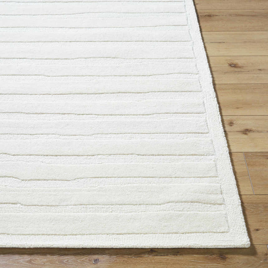 Close up of the Zerah White Wool Area Rug showing textured stripes on wood floor. Front