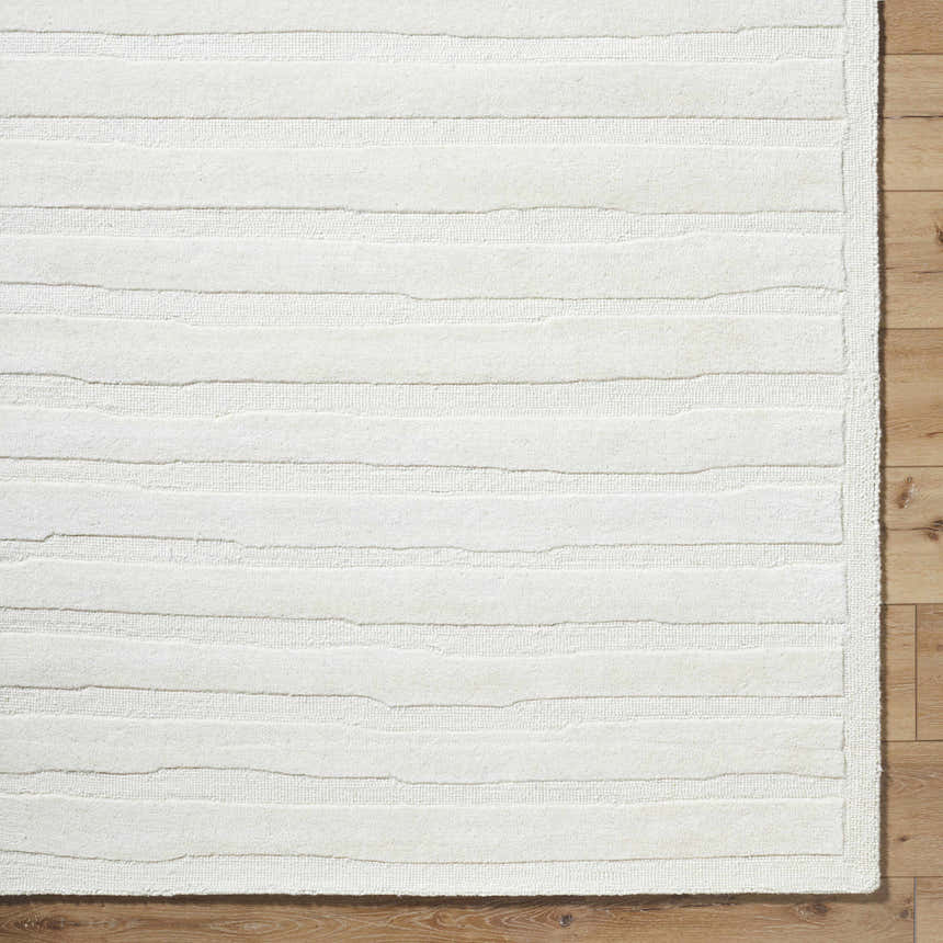 Close up of the textured, off white Zerah White Wool Area Rug with horizontal bands on wood floor. Swatch