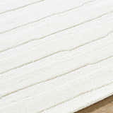 Close up of the textured, striped design of the Zerah White Wool Area Rug. Texture
