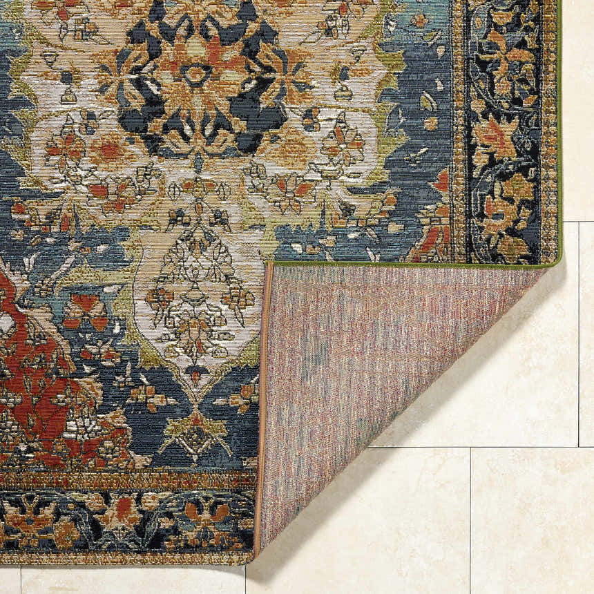 Close-up of the Zorea Traditional Area Rug showing the floral pattern, texture, and backing. Fold