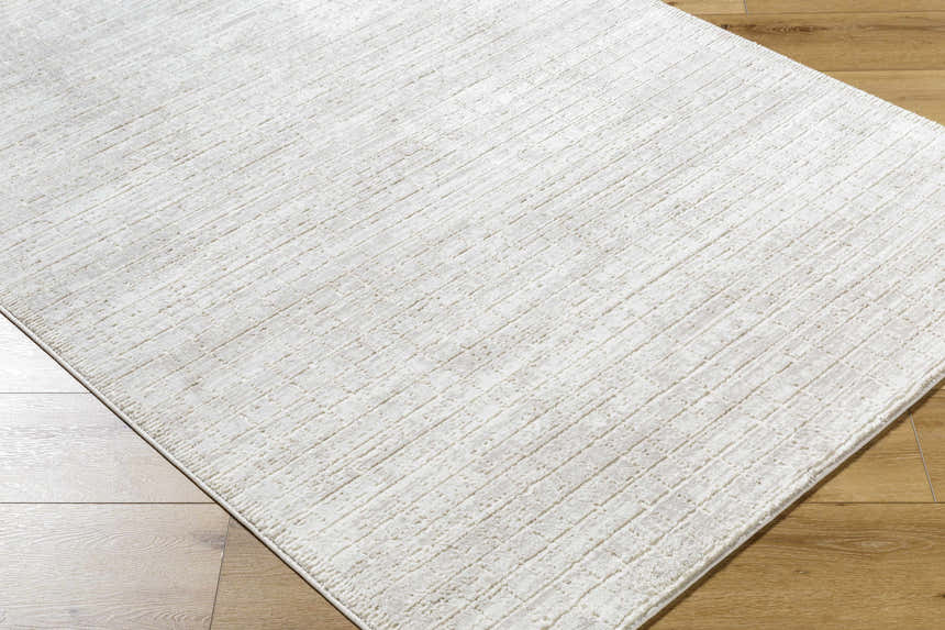 Close-up of the Arnulf 3D Textured Washable Rug in cream and ivory, showcasing its subtle geometric pattern and soft texture. Corner