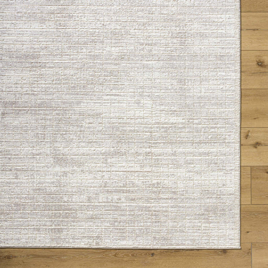 Close-up of the Arnulf 3D Textured Washable Rug in cream, ivory, and taupe on wood flooring. Shows texture and pattern. Swatch
