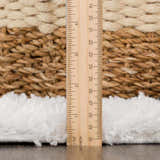 Close-up of the Zahur Black & White rug showing texture and pile height with a ruler. Pile