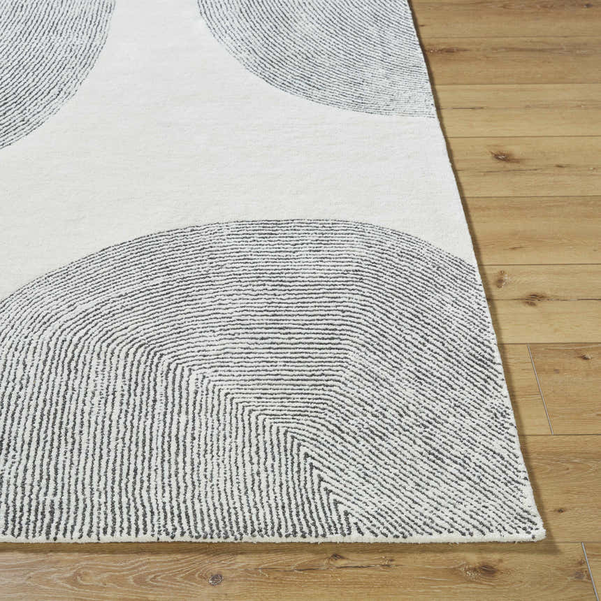 Close up of the hand-tufted Zytka Area Rug. Desert Sand and Silver Gray wool with a contemporary circle pattern. Front