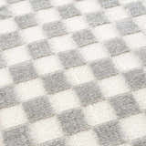 Close-up of Gaiwan Cream Gray Washable Area Rug showing checkerboard pattern and soft, textured weave. Texture