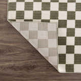 Close-up of the Kaysar Olive Green Checkered Washable Area Rug showing the checkered pattern and rug backing. Fold