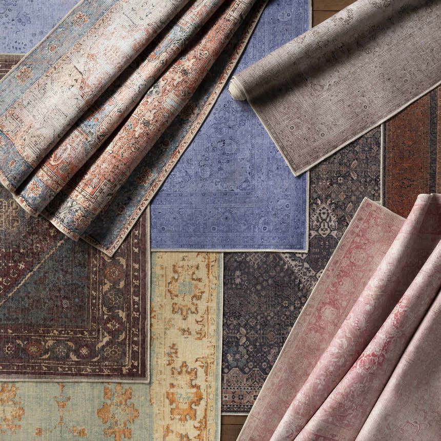 Close-up of multiple Livabliss Amelie AML-2309 Washable Area Rugs in beige, pink, gray, blue, rust, and tan colors. Styleshot