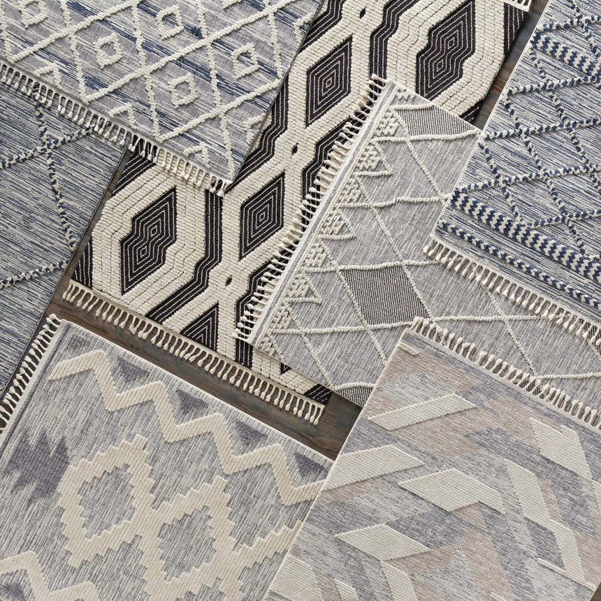 Close-up of Hesperus High/Low Pile Rugs with Tassels. Geometric designs in black, ivory, and gray. Bohemian, farmhouse style. Styleshot