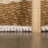 Close-up of the Ramsbury Wool Area Rug showing the texture, ivory and black fibers, and hand-woven construction. Pile
