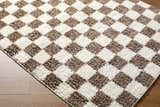 Close-up of the Neftekamsk area rug, a contemporary design with a brown and white checkerboard pattern. Fluffy texture. Corner