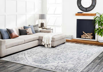 Living room scene with a light gray sectional sofa and the Darfield Area Rug in black and light gray. Roomscene-Rectangle