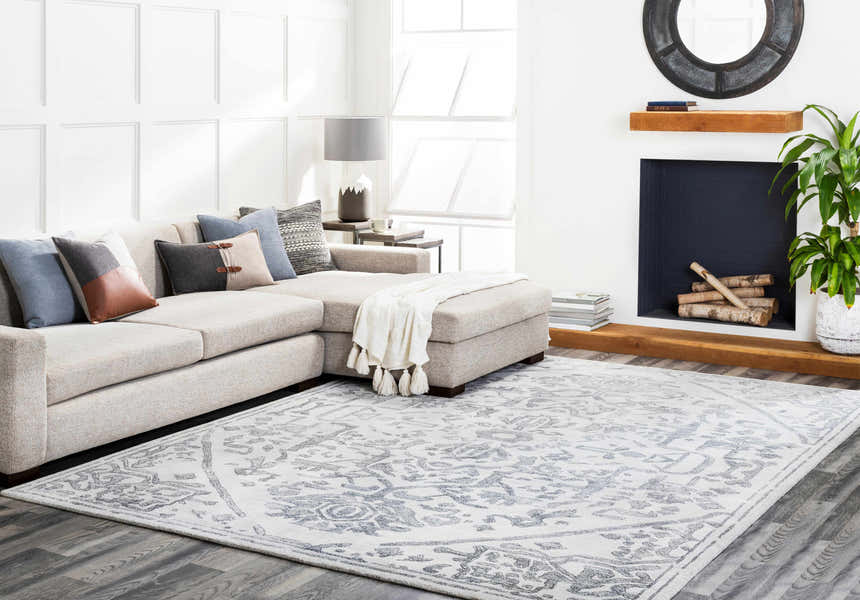Living room scene with a light gray sectional sofa and the Darfield Area Rug in black and light gray. Roomscene-Rectangle
