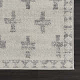 Close-up of the Tigris Swiss Cross Ivory&Gray Area Rug showing the gray geometric cross pattern and soft, textured ivory pile. Swatch