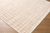 Close-up of the Odeon Elle Decor x LIVABLISS EDOD-2300 rug. Beige and ivory rug with a textured geometric grid pattern. Corner