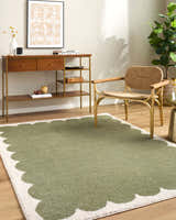 Living room scene with Rivoli Elle Decor x LIVABLISS EDRV-2303 rug in cream and olive, wood console table, and woven chair. Roomscene-Rectangle