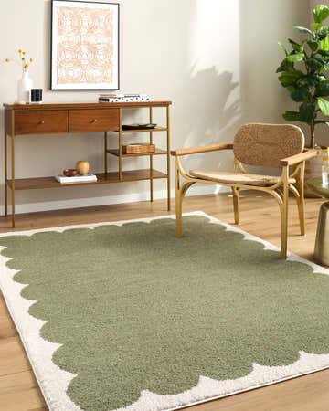 Living room scene with Rivoli Elle Decor x LIVABLISS EDRV-2303 rug in cream and olive, wood console table, and woven chair. Roomscene-Rectangle