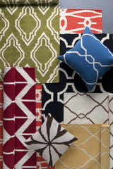 Melbeta Area Rug and other rugs with geometric patterns in green, red, black, yellow, and cream colors. Pillows included. Styleshot