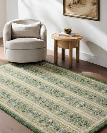 Living room scene with a Callen Light Green Area Rug, beige chair, and wooden side table. Roomscene-Rectangle