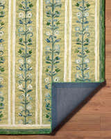 Close-up of the Callen Light Green Area Rug, a hand-tufted wool rug with a floral stripe pattern. Fold