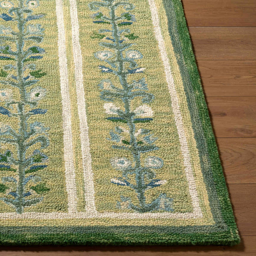 Close-up of the hand-tufted Callen Light Green Area Rug. Features a floral pattern, stripes, and a textured wool pile. Front