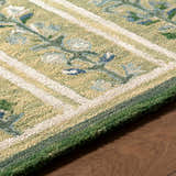 Close up of the hand-tufted Callen Light Green Area Rug. Features a floral pattern, wool texture, and farmhouse style. Texture