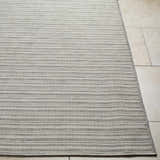 Close-up of the Greg Area Rug in lambswool and multi brown, showing its woven texture and subtle striped pattern. Front