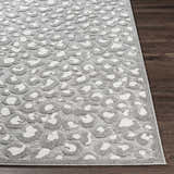 Close-up of the Greensborough Performance Rug. Gray and white animal print on a textured, machine-woven polypropylene rug. Front
