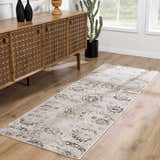 Entryway scene with a Georgiana Area Rug in beige, black, and gray. Wooden console table and cactus near a window. Roomscene-Runner
