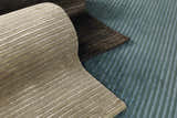 Close-up of the striped Sanatoga Area Rug in beige, brown, and blue. Hand-knotted wool and viscose rug texture. Styleshot