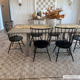 Farmhouse dining room with Ionut Checkered Jute Area Rug, wood table, black chairs, and neutral decor. Beige and tan rug. Roomscene-Rectangle