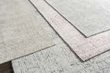 Close-up of Blackfoot Area Rug - Clearance. Hand-knotted viscose rug in black, white, and light pink with a farmhouse-style geometric pattern. Styleshot
