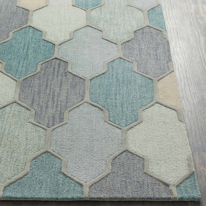 Close-up of Monteview Sage&Teal Geometric Wool Rug. Hand-tufted wool rug with geometric pattern in sage, teal, and gray hues. Front