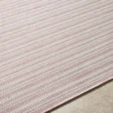 Close-up of the Greg Pink Area Rug showing the subtle pink and white striped pattern and woven texture. Texture