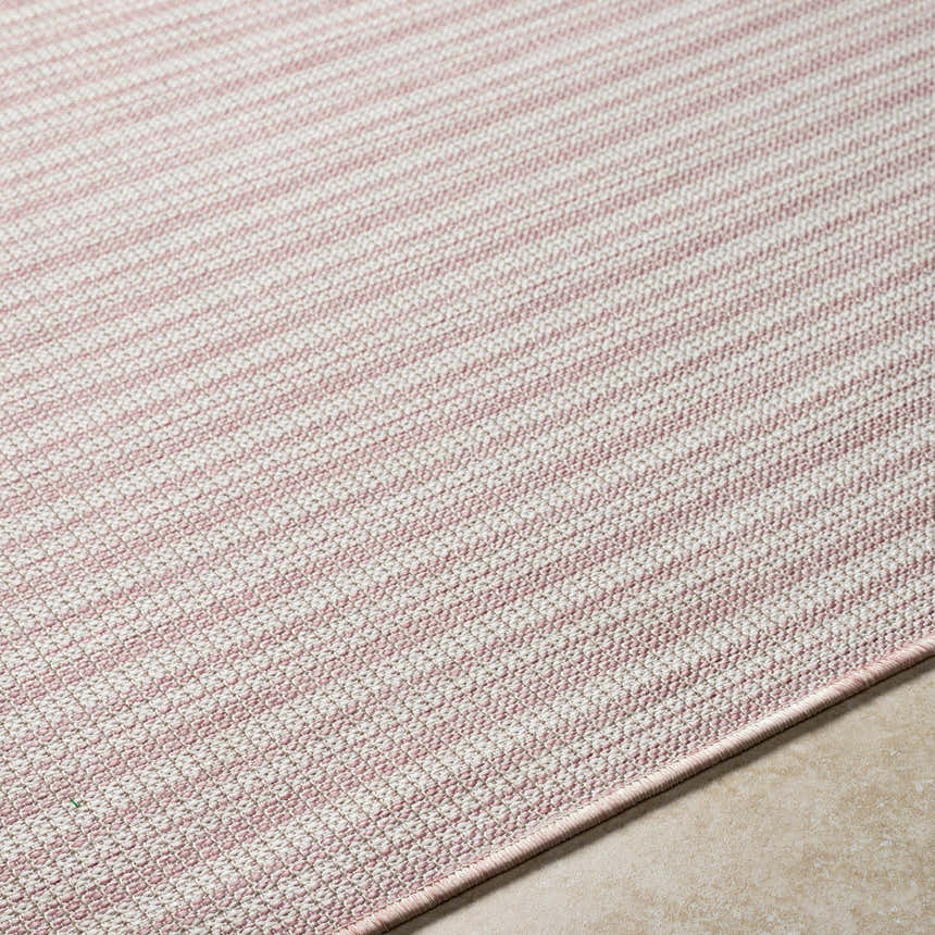 Close-up of the Greg Pink Area Rug showing the subtle pink and white striped pattern and woven texture. Texture