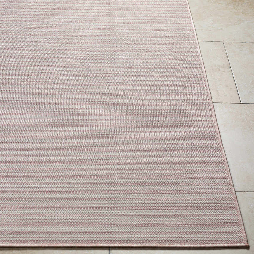 Close-up of Greg Pink Area Rug showing horizontal stripes and woven texture on a beige tile floor. Front