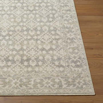 Close-up of Yureo Charcoal Persian rug showing beige and gray traditional pattern and machine woven texture on wood floor. Front