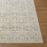 Close-up of the Aram Machine Woven Nabela Noor Home x LIVABLISS rug showing beige, charcoal, and light gray traditional pattern. Front