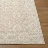 Close-up of Aram Machine Woven Nabela Noor Home x LIVABLISS rug. Ivory, tan, and gray traditional pattern. Front
