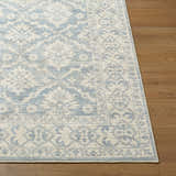 Close-up of the Aram Machine Woven Nabela Noor Home x LIVABLISS NBAR-2305 Area Rug in beige, denim and pale blue. Front