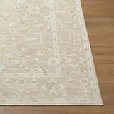 Close-up of Asha Machine Woven Nabela Noor rug showing jute and polyester texture, off-white and gray farmhouse pattern on wood floor. Front