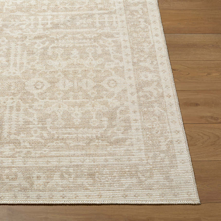 Close-up of the Athiyo Nabela Noor Home x LIVABLISS rug. Jute and polyester rug with a farmhouse-style pattern in gray, mustard, and off-white. Front