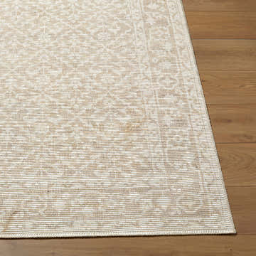 Close-up of Maan Machine Woven Nabela Noor Home x LIVABLISS NBMA-2300 Area Rug. Jute and polyester rug in medium gray, mustard, and off-white. Fold