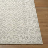 Close-up of Maan Machine Woven Nabela Noor Home x LIVABLISS NBMA-2301 Area Rug. Gray and off-white farmhouse design. Fold